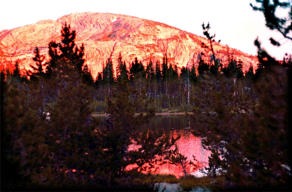 Sunset reflects on caldera wall of Harvey Lake, in Yosemite's high country.