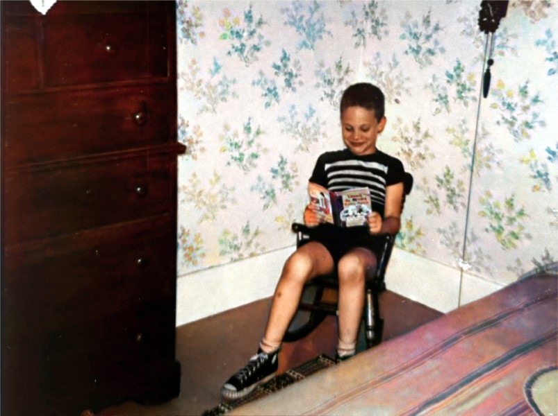 Me reading a Dennis the Menace paperback.