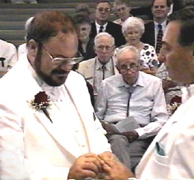 Paul and Michael exchanging rings.