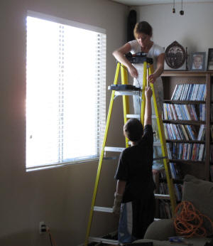 Zach and Jenny put up the curtains.
