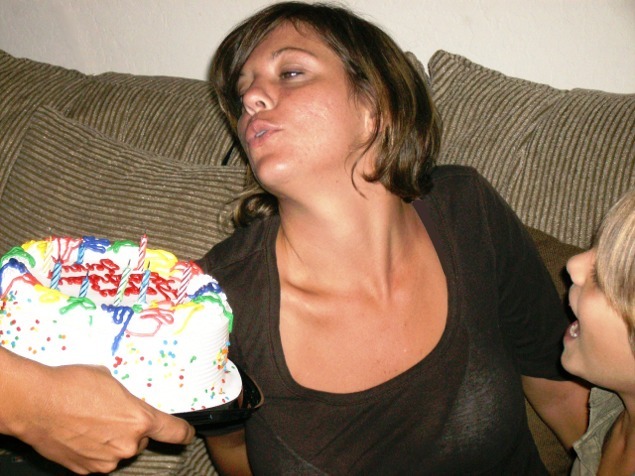 Blowing out her own candles.