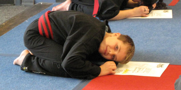 Zach wipes sweat into his new belt.