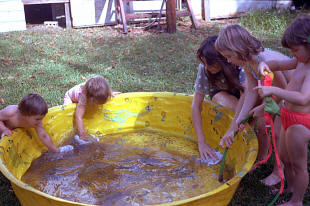 Rinsing sand off the pool.