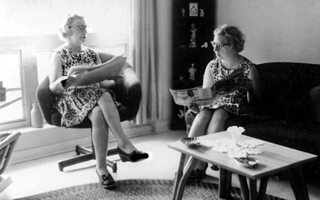 Twin Moms discuss newspaper articles. (This is science fiction!)