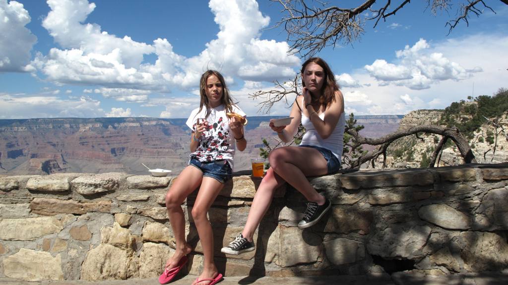 Patricia and Brianna eating on the ledge.
