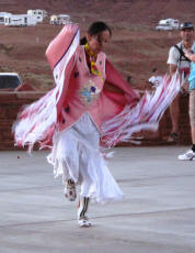 Navajo woman dancing in ceremonial garb.