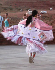 Navajo woman dancing in ceremonial garb.