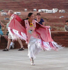 Navajo woman dancing in ceremonial garb.