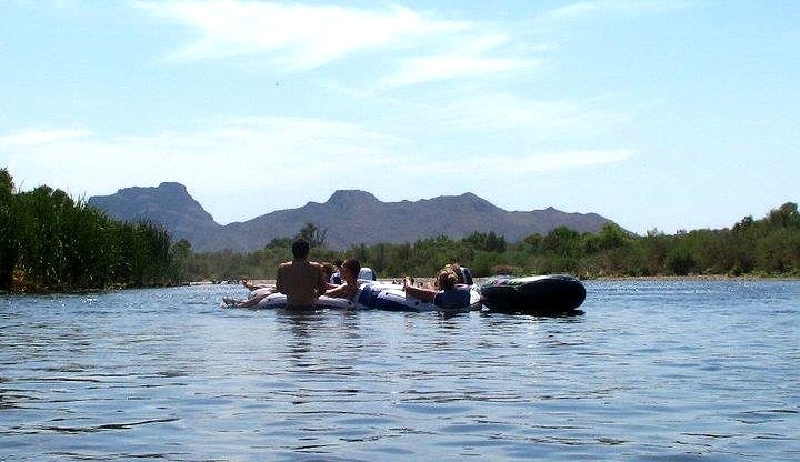The crowd disperses as the river widens.