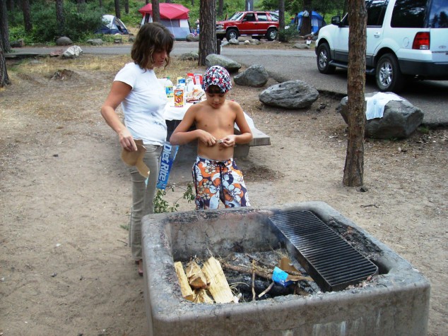 Zach lights the campfire.