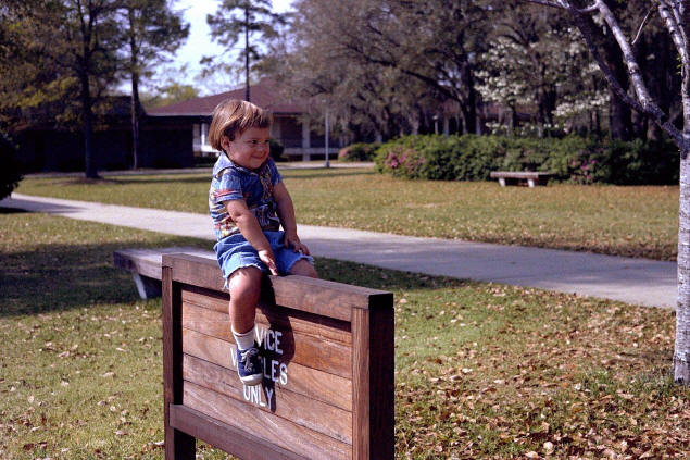Johnny sits on the sign for the back entrance of the Systems Science Lab.